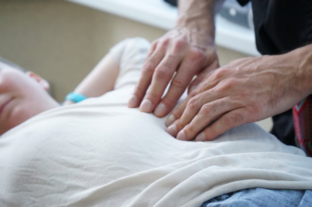 Close-up of hands performing a therapeutic massage indoors, enhancing relaxation and stress relief.